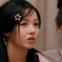 a close up of a girl with a star on her hair