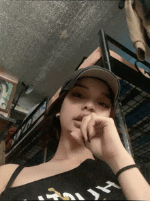a girl wearing a hat and a black shirt that says ' i 'm just ' on it