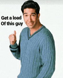 a man in a blue sweater is giving a thumbs up with the words get a load of this guy behind him