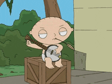 stewie from family guy is playing a banjo while sitting on a box .