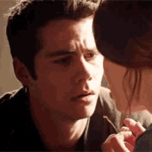 a man and a woman are looking at each other with their eyes closed