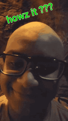 a man wearing glasses and a hat with the words howz it on top of him