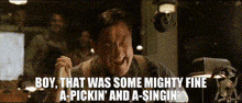 a man in a suit says boy that was some mighty fine a-pickin and a-singin .
