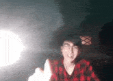 a man wearing glasses and a plaid shirt is giving a high five
