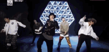 a group of young men are dancing in front of a screen that says ' una ' on it