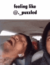 a man is sleeping in a car with the words feeling like @_puzzled above him