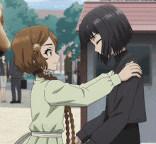 a girl with a flower in her hair is hugging a girl with black hair