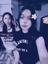 two girls are posing for a picture and one has a shirt that says jeep on it