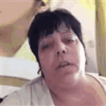a close up of a woman 's face with her eyes closed and her mouth open .