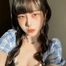 a woman in a plaid shirt is taking a selfie .