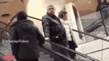a group of people are riding an escalator with the words whatsapp videos written on the bottom
