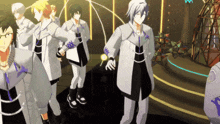 a group of anime characters are standing on a stage and one of them has the letter m on his shirt