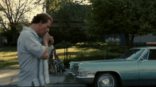 a man smoking a cigarette in front of a car