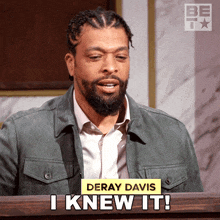 a man behind a podium with the name deray davis on his jacket