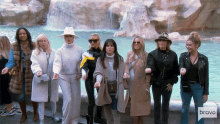 a group of women standing in front of a fountain with bravo written on the bottom right