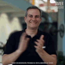 a man wearing a shirt that says javier maestro cervecero clapping his hands