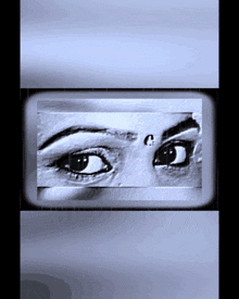 a black and white photo of a woman 's eyes