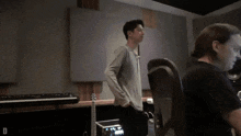 a man standing in a room with the letter d on the bottom