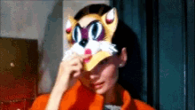 a woman wearing a cat mask covering her face