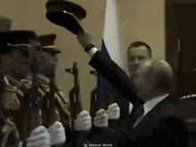 a man in a suit and tie is standing in front of a group of soldiers
