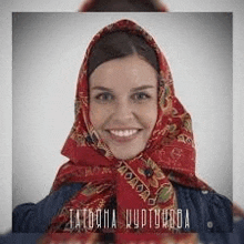 a woman is wearing a red scarf around her head .