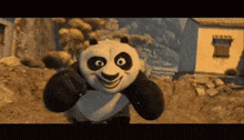 a panda bear from kung fu panda is smiling while standing in front of a building .