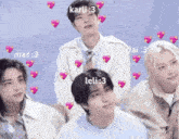a group of young men are standing next to each other with pink hearts surrounding them .