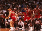 a group of basketball players are playing basketball on a court . one of the players is wearing a number 24 jersey .