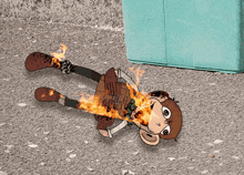 a cartoon monkey is laying on the ground with flames coming out of its mouth