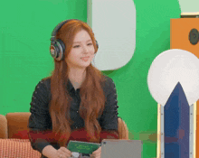 a woman wearing headphones is holding a tablet with the words wish card written on it