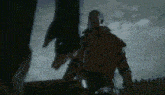 a blurry picture of a person holding a gun in a dark room .