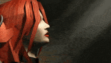 a close up of a woman 's face with red hair and red lips
