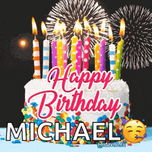 a birthday cake with candles and fireworks in the background for michael .