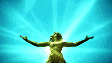 a statue with its arms outstretched against a blue sky
