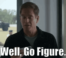 a man is holding a cell phone and saying well go figure .