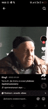 a phone screen shows a video of an old man talking