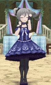 a girl in a blue dress is standing in front of a table with flowers on it
