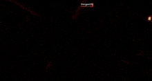 a person in a red shirt with a skull on it is holding a gun in a video game
