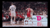 a basketball game is being played in front of an advertisement for t-mobile