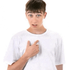 a young boy in a white shirt is pointing at his chest .