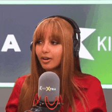 a woman wearing headphones and a microphone that says kiss extra