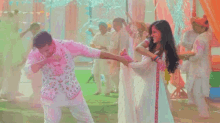 a man and a woman are dancing together in front of a crowd