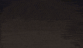 a blurred image of a fireworks display with a few lights in the foreground
