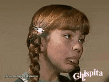 a girl with red hair is smiling with the word chispita on the bottom right
