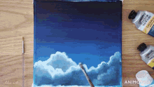 a painting of clouds is being painted with winsor newton galeria