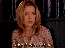 a woman says " take it easy joan " in a floral shirt