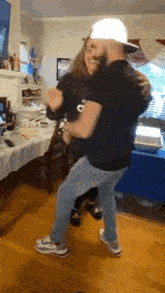 a man and woman are dancing in a living room .