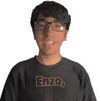 a man wearing glasses and a shirt that says enzo on it