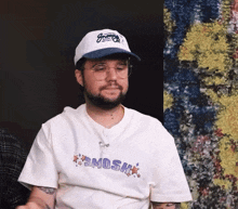 a man wearing a snoopy hat and a shirt that says smosh