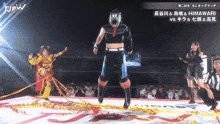 a man in a mask stands on a wrestling ring in front of a referee
